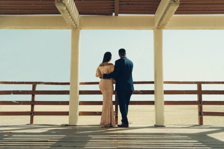 man and woman standing on wooden dock during daytime