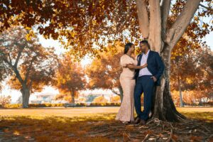 couple kissing under brown tree during daytime